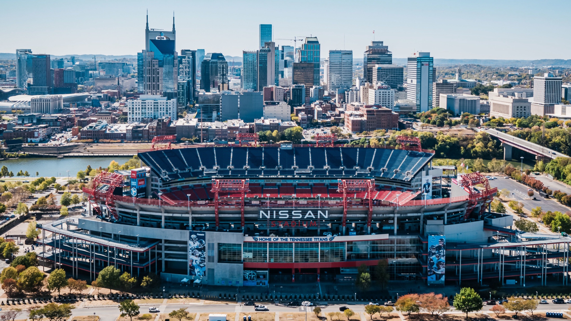 Aerial view of Nissan Stadium in Nashville with downtown skyline behind